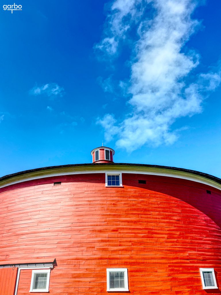 Red round barn and blue sky